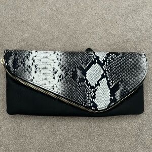 Black and White Snakeskin Clutch with gold cross body chain.